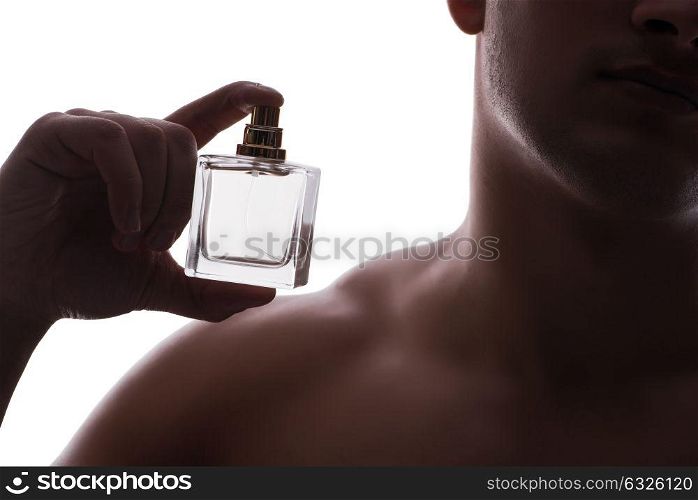 Sexy man with bottle of perfume