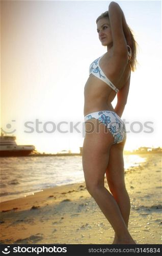 Sexy model poses by the beach