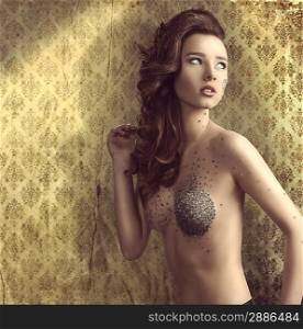 sexy naked lady with modern hair-style and bright make-up. Small piece of mirror on visage and breast.vintage color wallpaper
