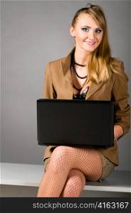 sexy provocative business woman at office with laptop