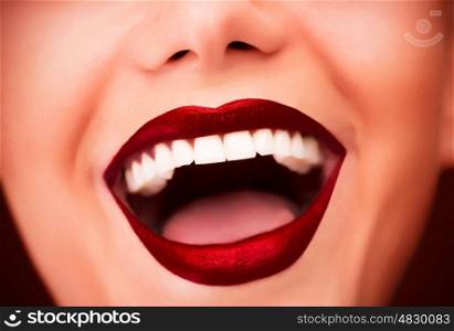 Sexy red glossy lips, model with fashion makeup, face part, beautiful white teeth, female laughing facial expression, glamor concept