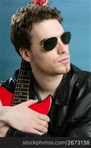 sexy rock man sunglasses and leather black jacket over blue