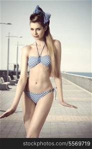 sexy slim girl with long blonde hair posing in summer portrait, wearing bikini and vintage foulard in the hair
