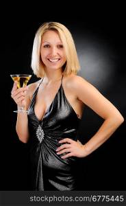 Sexy smiling blonde standing with goblet, hand on hip