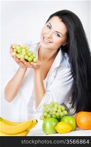 sexy smiling woman with grape in hands