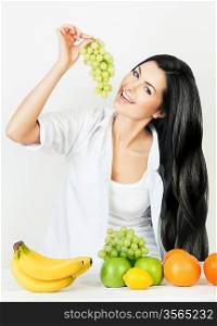 sexy smiling woman with grape in right hand