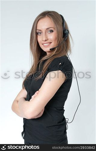 Sexy smilling call center operator. Girl wearing headset standing on uniform background. One of a series. Business collection.