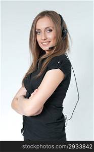 Sexy smilling call center operator. Girl wearing headset standing on uniform background. One of a series. Business collection.