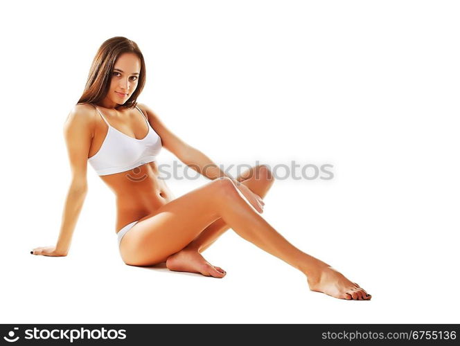 Sexy sporty woman siting on the floor on white background