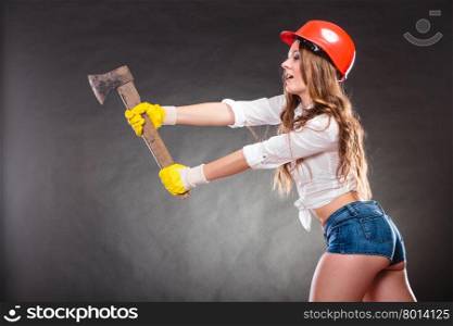 Sexy strong woman feminist with axe working.. Sexy alluring woman wearing helmet hitting with axe chopper. Strong girl feminist working in man profession. Independent female.