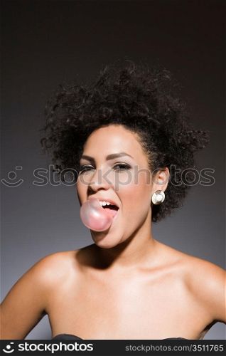 Sexy Woman Blowing Bubble Gum Bubble, Studio Portrait