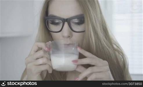 sexy woman drinking milk in the kitchen