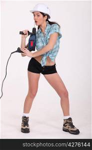 Sexy woman holding an electric screwdriver