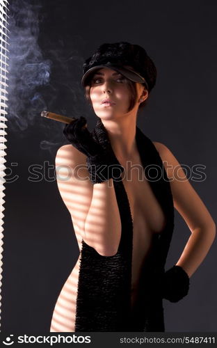 sexy woman in black astrakhan smoking cigar