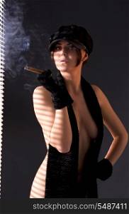 sexy woman in black astrakhan smoking cigar