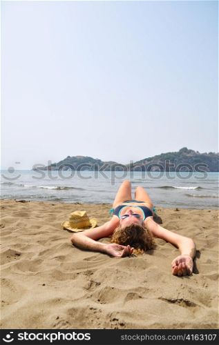 sexy woman is lying on the beach
