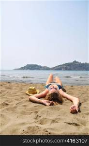sexy woman is lying on the beach
