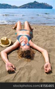 sexy woman is lying on the beach and, top view
