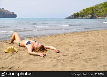 sexy woman is lying on the wild beach