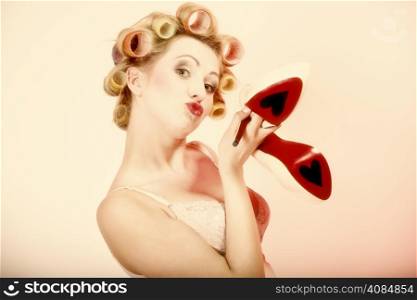 Sexy woman preparing to party, girl in underwear curlers in hair with high heels shoes having fun pink background. Valentine&#39;s day romantic holiday, love concept.