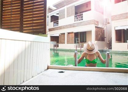 Sexy woman wearing bikini in swimming pool. Summer vacation concept