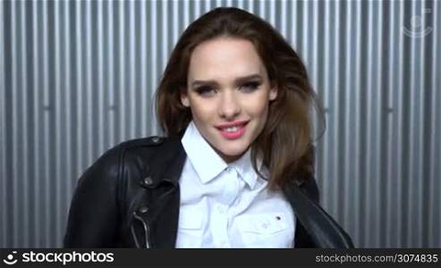 Sexy woman wearing leather jacket and shirt in the car park garage