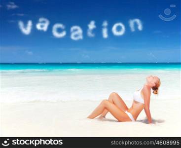 Sexy woman with closed eyes taking sunbath on beautiful sandy seashore, enjoying day spa, luxury tropical resort, summer vacation concept