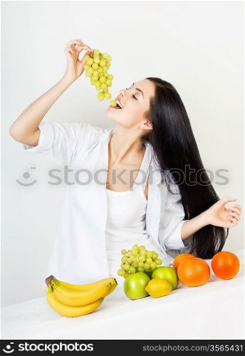 sexy woman with green grape in hand