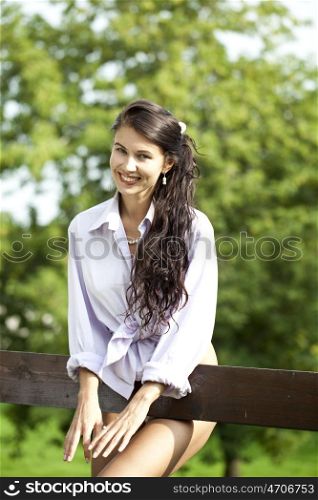 Sexy young Brunette in a summer park