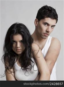 Sexy young couple isolated on a gray background