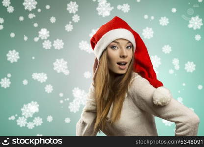 sexy young female with long smooth hair wearing warm sweater and funny red christmas hat . Winter xmas portrait