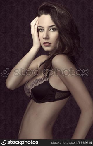 sexy young girl with bra lingerie in a grunge fashion shot. looking in camera