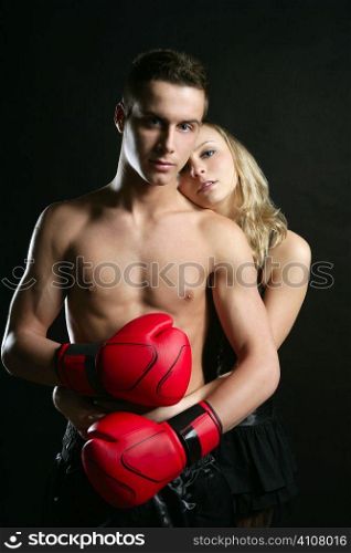 Sexy young male boxer with blond beautiful girl, isolated on black studio shot