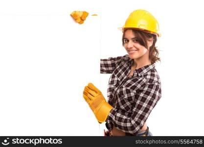 Sexy young woman construction worker, holding a white board