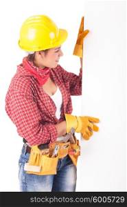 Sexy young woman construction worker, holding a white board