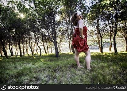 Sexy young woman in red dress, detail of sensuality and beauty