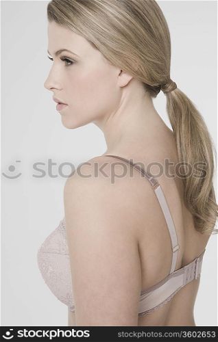 Sexy young woman wearing bra, profile