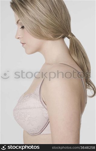 Sexy young woman wearing bra, profile
