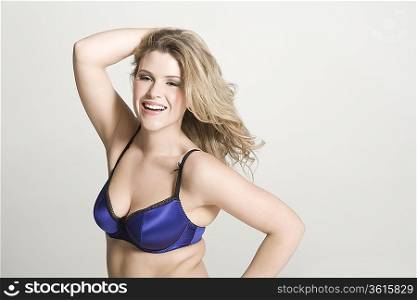 Sexy young woman wearing bra, smiling