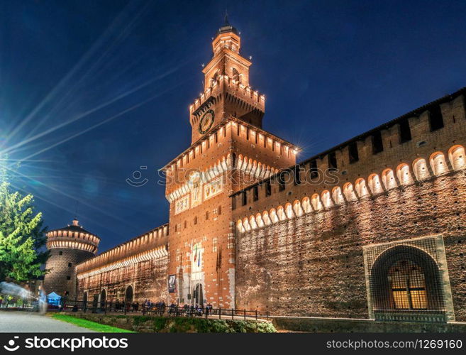 Sforza Castle (Castello Sforzesco) at night in Milan, Italy. The castle was built in the 15th century by Sforza, Duke of Milan. It is the main travel destination for tourist visiting Milan, Italy.