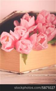 Shabby chic decoration - pink tulips in vintage book. Tulips in book