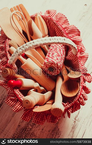 Shabby chic rustic basket with wooden kitchen utensils. wooden kitchen utensils