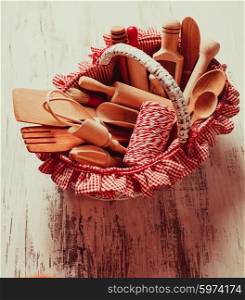 Shabby chic rustic basket with wooden kitchen utensils. wooden kitchen utensils