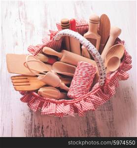 Shabby chic rustic basket with wooden kitchen utensils. wooden kitchen utensils