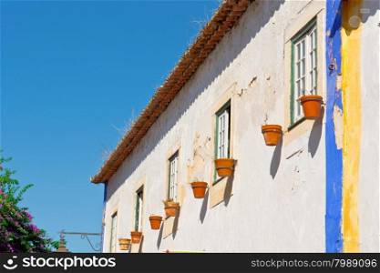 Shabby Facade of Portuguese House Decorated with Flower Pots