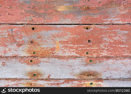 Shabby pink painted boards with small holes