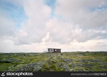 Shack in rugged landscape