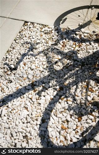 Shadow of a bicycle falling on pebbles, Washington DC, USA