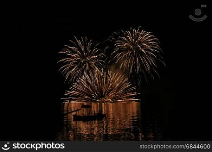 Shadow of a boat with firework in the background at toya lake during firework festival, Hokkaido, Japan
