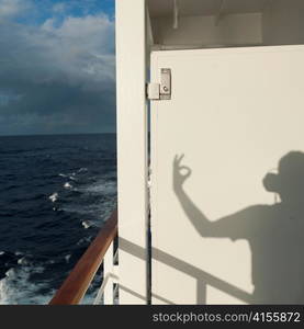 Shadow of a person gesturing on a cruise ship Silver Shadow, East China Sea